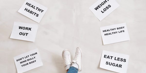 Inspirational health and fitness messages with shoe-clad feet, promoting healthy habits and wellbeing.